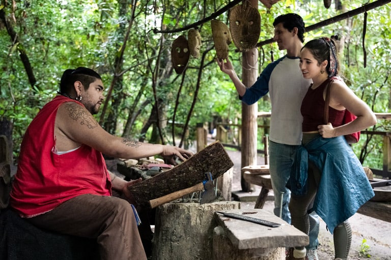 couple looking at wooden masks