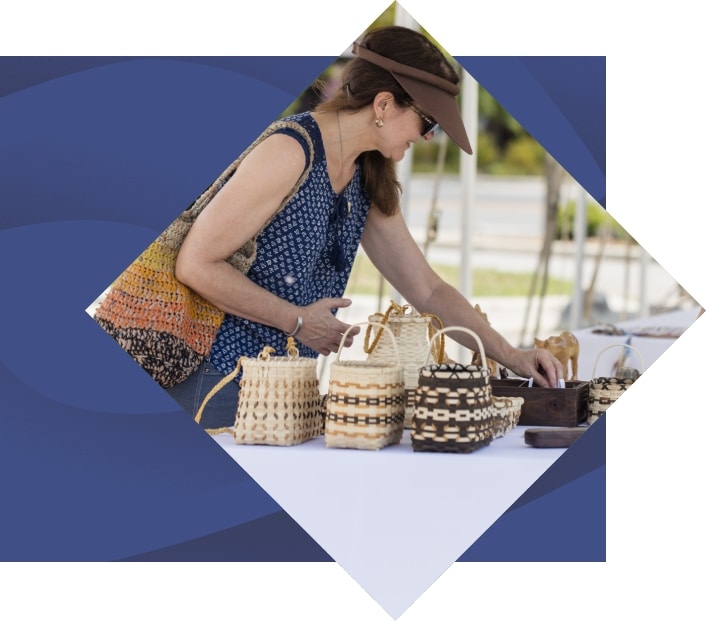 island park art market shopper looking at baskets
