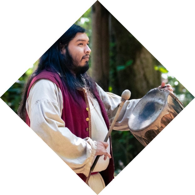 man playing handheld drum