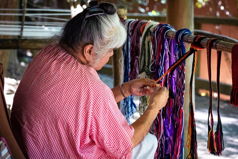 women braiding strings