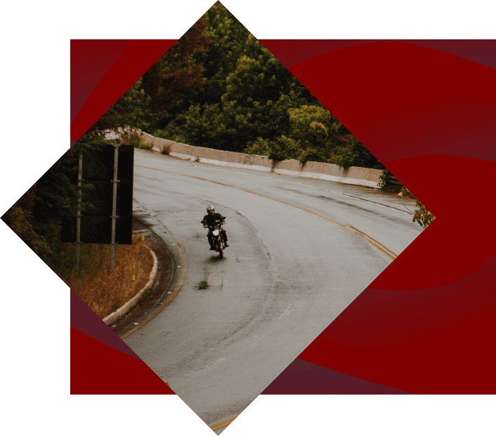 Motorcycle rider on road in cherokee nc with trees in the background