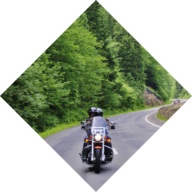 Motorcycling in NC on road with mountain in background